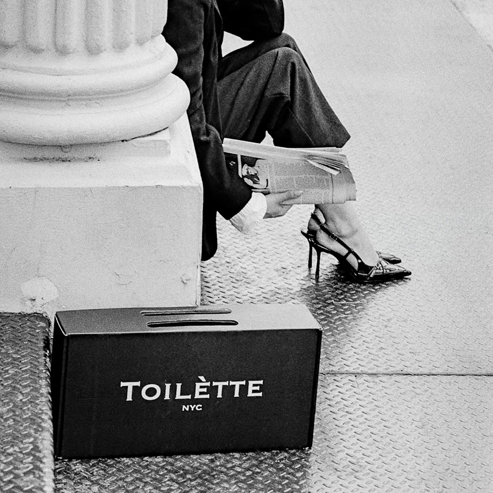 girl on stoop in nyc with toilette box