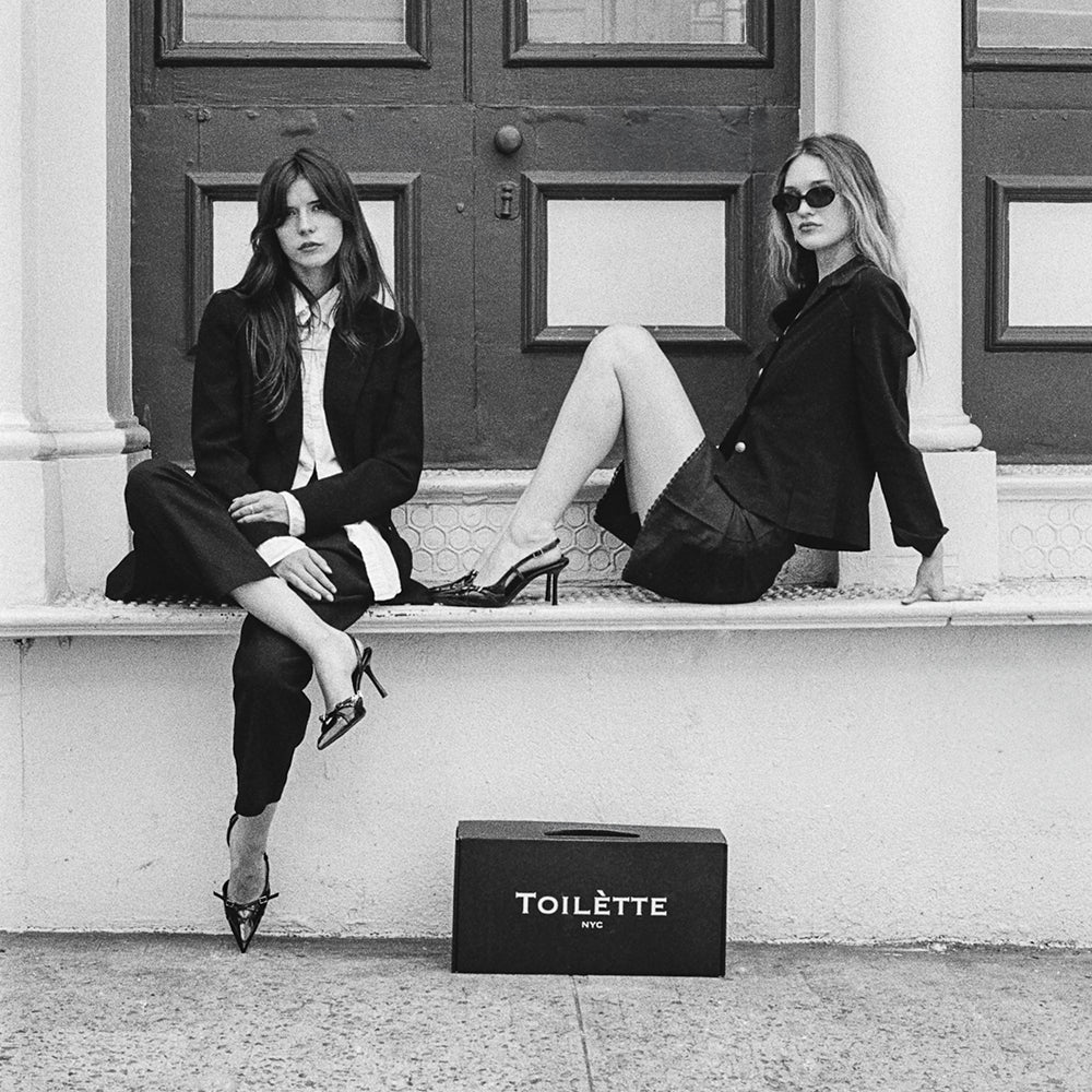 two girls on stoop in nyc with Toilètte box
