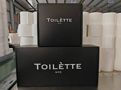 Two black boxes with 'Toilette NYC' branding